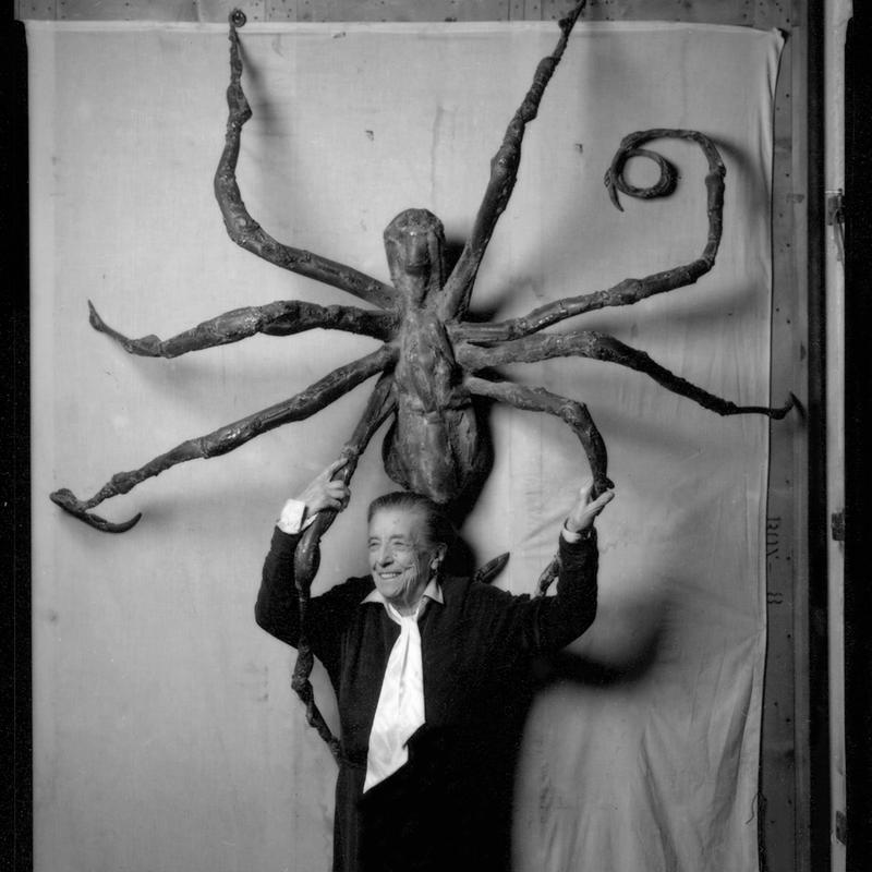 Artist Louise Bourgeois stands before her sculpture 'Spider IV,' in 1996.